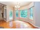 Sunlit dining area with hardwood floors, chandelier, and exterior door to deck at 500 Barrington Farms Pkwy, Sharpsburg, GA 30277