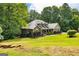 Beautiful house surrounded by lush trees and a well-maintained lawn at 500 Barrington Farms Pkwy, Sharpsburg, GA 30277