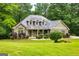 Charming home with a stone facade, inviting curb appeal, and lush green landscaping at 500 Barrington Farms Pkwy, Sharpsburg, GA 30277