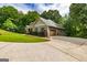 Home exterior featuring an attached garage and well-groomed landscaping at 500 Barrington Farms Pkwy, Sharpsburg, GA 30277