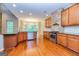 Open kitchen with stainless steel appliances, granite countertops, and dark wood flooring at 500 Barrington Farms Pkwy, Sharpsburg, GA 30277