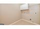 This is an image of a Laundry Room area with a white storage cabinet and some shelving at 500 Barrington Farms Pkwy, Sharpsburg, GA 30277