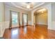 Open living area with hardwood floors, crown molding, and lots of natural light at 500 Barrington Farms Pkwy, Sharpsburg, GA 30277