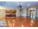 Spacious living room with a stone fireplace, hardwood floors, and open kitchen access at 500 Barrington Farms Pkwy, Sharpsburg, GA 30277