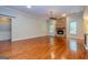 Large open living area with stone fireplace and hardwood floors throughout at 500 Barrington Farms Pkwy, Sharpsburg, GA 30277