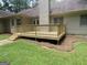 View of the home's back deck with steps down to the lawn, offering a relaxing outdoor space for entertaining at 56 Ridgewood Ct, Mcdonough, GA 30252