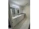 Bright bathroom featuring double sinks, granite countertops, and stylish tile flooring at 56 Ridgewood Ct, Mcdonough, GA 30252