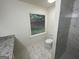 Bathroom with marble-look tile, window, and tiled shower with hexagon base at 56 Ridgewood Ct, Mcdonough, GA 30252