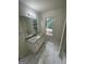 Bright bathroom with single sink, granite countertops, and tile flooring at 56 Ridgewood Ct, Mcdonough, GA 30252