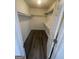 Walk-in closet with built-in shelving and dark wood-look flooring at 56 Ridgewood Ct, Mcdonough, GA 30252