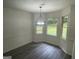 A bright dining room boasts wainscoting, modern floors, and a view of the backyard, perfect for Gathering meals at 56 Ridgewood Ct, Mcdonough, GA 30252