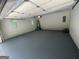 The garage features newly painted flooring, offering a clean and functional space for parking and storage at 56 Ridgewood Ct, Mcdonough, GA 30252