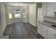 An eat-in kitchen features modern flooring, white cabinets, and updated countertops, perfect for cooking and entertaining at 56 Ridgewood Ct, Mcdonough, GA 30252