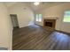 A spacious living room features vaulted ceiling, fireplace, and modern floors, perfect for Gathering gatherings at 56 Ridgewood Ct, Mcdonough, GA 30252