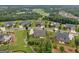 Aerial view showcases a beautifully landscaped property, golf course, and mature trees at 406 Horizon Trl, Canton, GA 30114