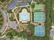 Aerial view showcases a golf course and country club surrounded by lush greenery and picturesque views at 406 Horizon Trl, Canton, GA 30114