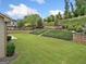 Expansive backyard features a well-manicured lawn and stone retaining walls with lush landscaping at 406 Horizon Trl, Canton, GA 30114