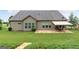 Exterior view of a home showcasing a well-manicured lawn and cozy patio with a retractable awning at 406 Horizon Trl, Canton, GA 30114