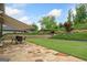 Manicured backyard features an expansive lawn, layered landscaping, and a cozy outdoor seating area at 406 Horizon Trl, Canton, GA 30114