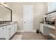 Well-lit bathroom with granite countertop vanity, white cabinets, and large mirror at 406 Horizon Trl, Canton, GA 30114