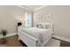 Neutral bedroom featuring hardwood floors, white trim, and large window with shutters at 406 Horizon Trl, Canton, GA 30114
