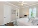 Bright bedroom with hardwood floors, ceiling fan, and ensuite bathroom access at 406 Horizon Trl, Canton, GA 30114