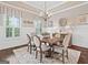 Bright dining room featuring large windows, wainscoting, and a stylish chandelier at 406 Horizon Trl, Canton, GA 30114
