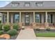 Inviting front porch with stone columns, shutters, and manicured landscaping at 406 Horizon Trl, Canton, GA 30114