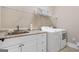 Functional laundry room with sink, cabinets, and modern appliances at 406 Horizon Trl, Canton, GA 30114