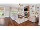 Inviting living room with stone fireplace, built-in shelves, and hardwood floors at 406 Horizon Trl, Canton, GA 30114