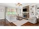 Living room featuring fireplace, built-in shelves, and a ceiling fan at 406 Horizon Trl, Canton, GA 30114