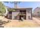 Exterior of home featuring deck, backyard, and wooded area at 4595 Carriage Walk Ln, Cumming, GA 30040