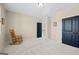 Bedroom with neutral walls, plush carpeting, white trim, rocking chair, and black doors at 4595 Carriage Walk Ln, Cumming, GA 30040