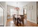An elegant dining room with hardwood flooring, trim accents, and a decorative chandelier at 4595 Carriage Walk Ln, Cumming, GA 30040