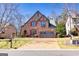 Beautiful stone home featuring a well-manicured lawn and a two-car garage at 4595 Carriage Walk Ln, Cumming, GA 30040
