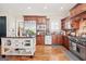 Kitchen featuring stainless appliances, a center island, and wood cabinetry at 4595 Carriage Walk Ln, Cumming, GA 30040