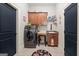 Well-organized laundry room with modern washer/dryer and ample cabinet space at 4595 Carriage Walk Ln, Cumming, GA 30040