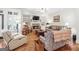 Inviting living room with a stone fireplace and built-in shelving at 4595 Carriage Walk Ln, Cumming, GA 30040