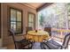Inviting back porch with table, chairs and view of wooded backyard at 4595 Carriage Walk Ln, Cumming, GA 30040