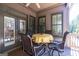Inviting back porch with table, chairs and view of wooded backyard at 4595 Carriage Walk Ln, Cumming, GA 30040