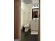 Bathroom with wainscotting, toilet, and vanity with black accents and dark tile floors at 219 Brown Branch Rd, Locust Grove, GA 30248