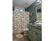Inviting bathroom featuring floral shower curtain and matching earth-toned rug at 219 Brown Branch Rd, Locust Grove, GA 30248