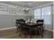 A modern dining room features decorative lighting, wainscoting on the walls, and a view of a sunlit window at 219 Brown Branch Rd, Locust Grove, GA 30248