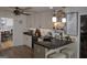 Bright kitchen with a breakfast bar, white cabinetry, modern appliances, and hardwood flooring at 219 Brown Branch Rd, Locust Grove, GA 30248