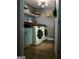 Functional laundry room features a countertop, shelving, and modern appliances at 219 Brown Branch Rd, Locust Grove, GA 30248