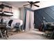 Office with laminate floors, black chairs, shelving, and a blue accent wall and curtain at 219 Brown Branch Rd, Locust Grove, GA 30248