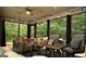 Inviting screened porch with comfortable seating, dining table, and wood ceiling for outdoor relaxation at 219 Brown Branch Rd, Locust Grove, GA 30248