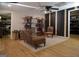 Sitting room with a chaise lounge, decorative shelving, accent wall, and laminate floors at 219 Brown Branch Rd, Locust Grove, GA 30248