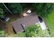 An aerial view showcases a well-maintained home surrounded by lush greenery with a driveway and ample parking at 85 Pine Haven Dr, Carrollton, GA 30116