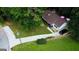 Aerial view of a well-maintained property featuring a spacious driveway and landscaped backyard at 85 Pine Haven Dr, Carrollton, GA 30116